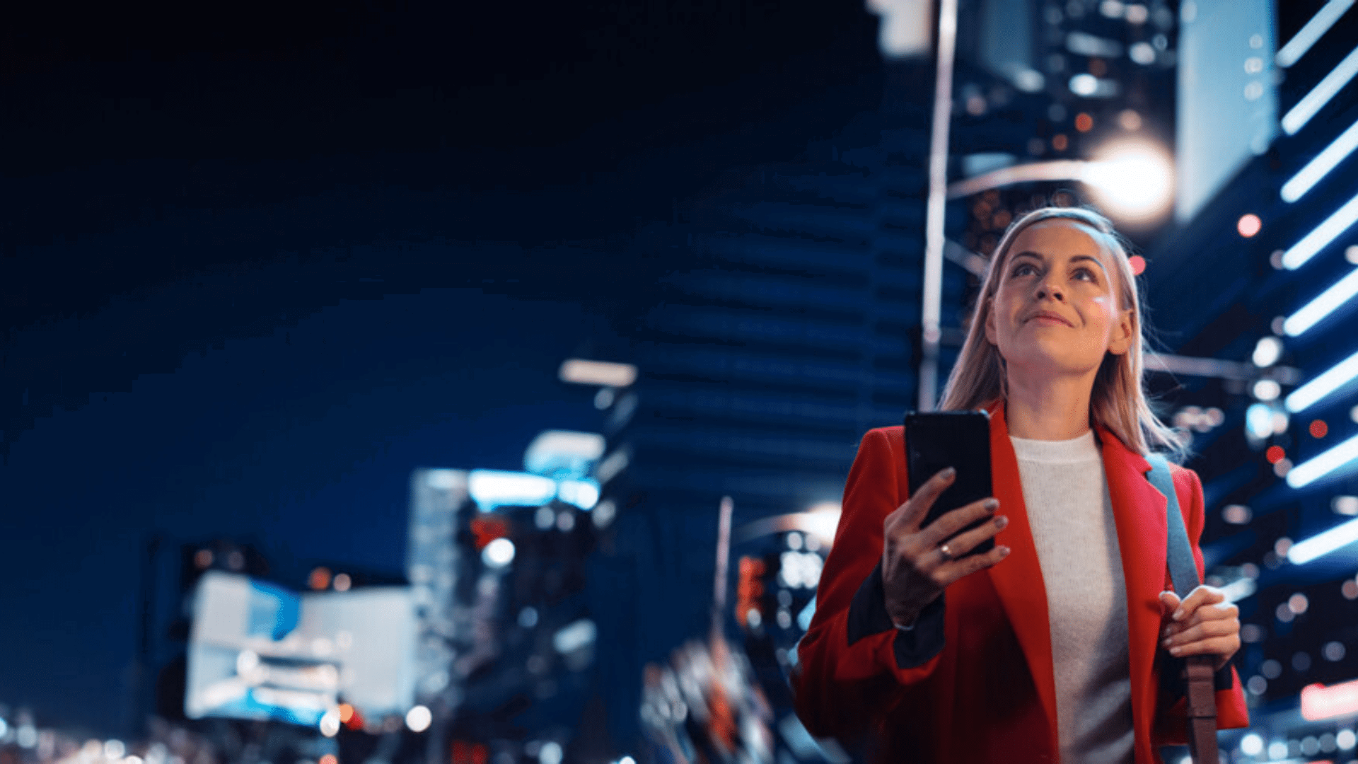 cloud telephony hero image - women in red in city on the a mobile
