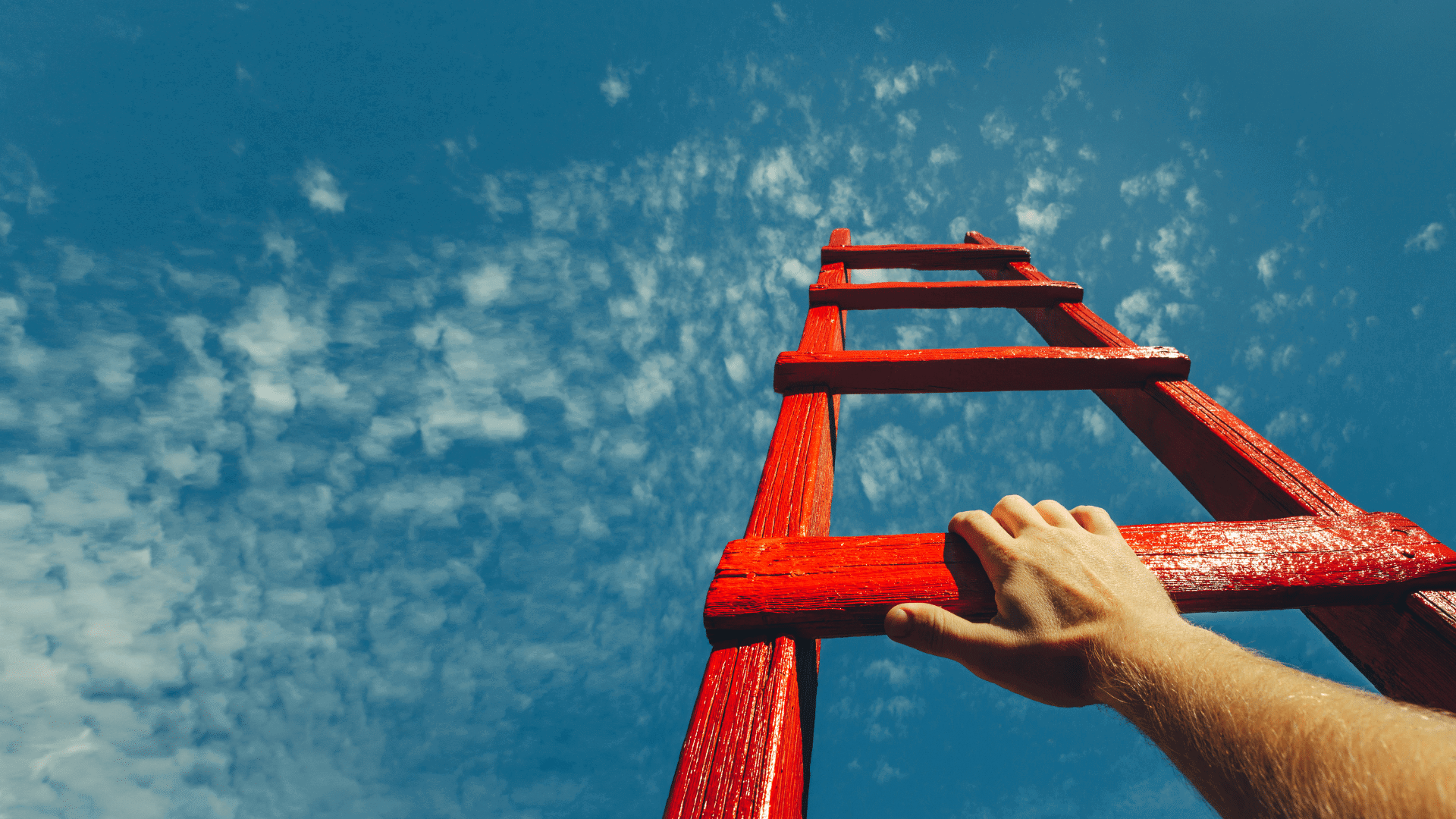 cyber security service - proactive security business solution hero image of a hand on a red ladder, against a back drop of blue sky