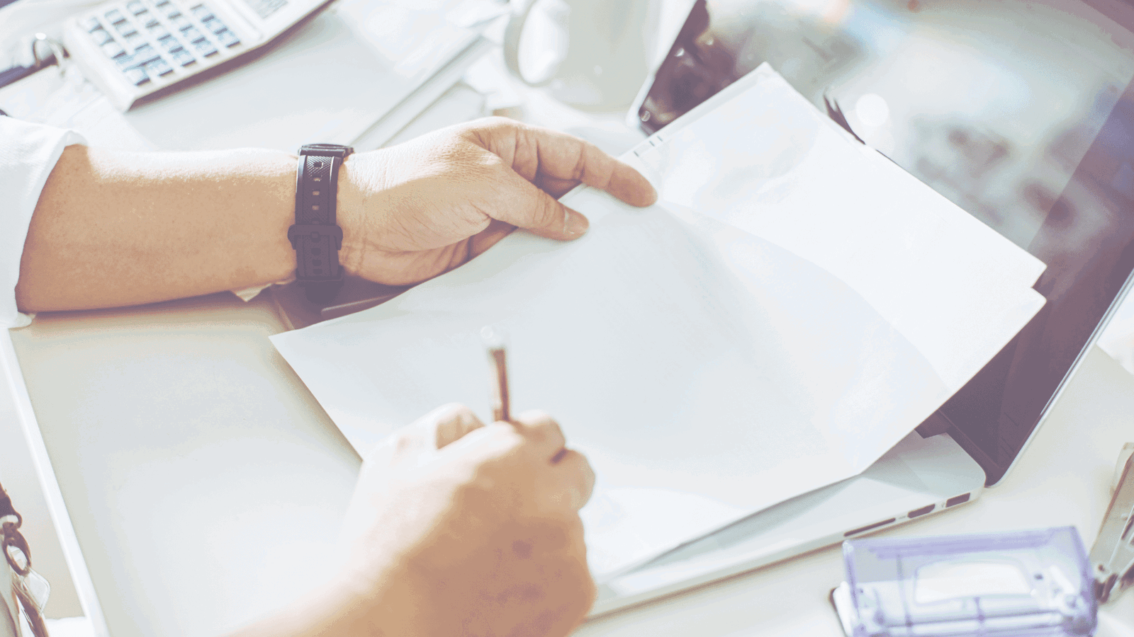 taxassist hero image - picture of a accountant working at a desk